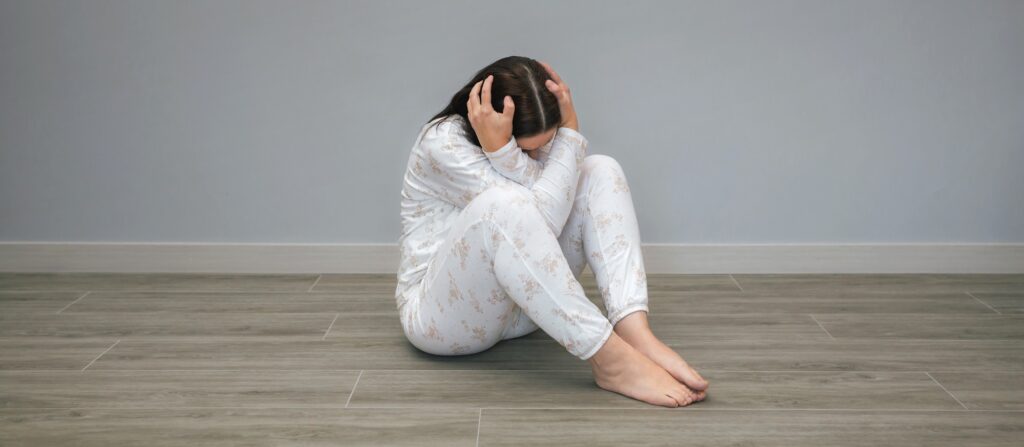 Unrecognizable woman with mental disorder and suicidal thoughts